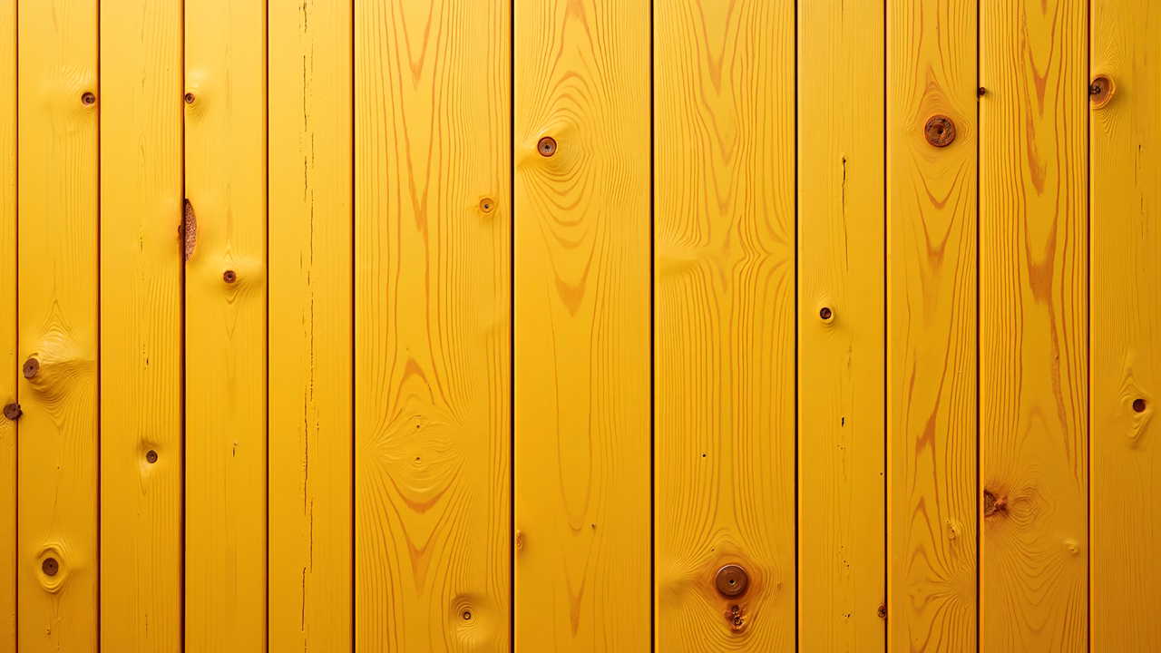 Bright yellow wooden fence with natural grain patterns.