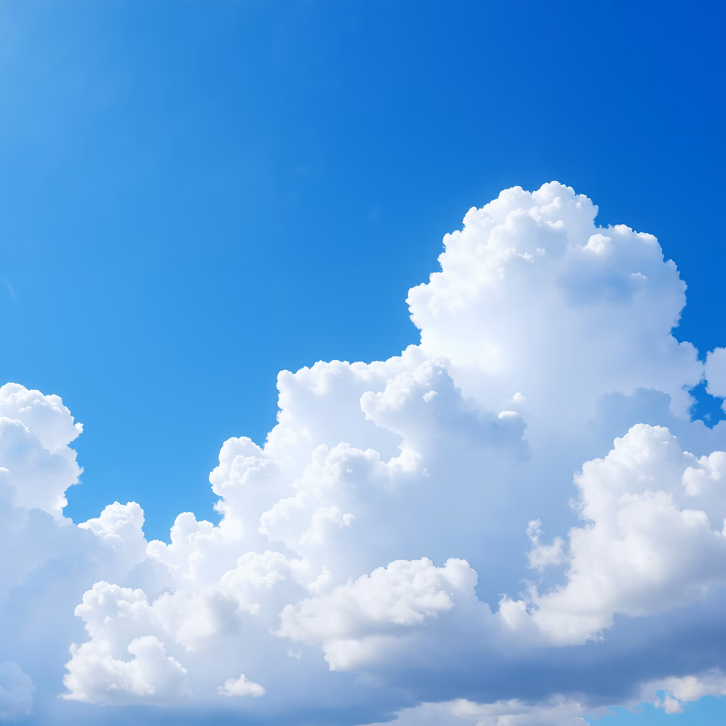 Vibrant blue sky with fluffy white clouds, serene and open.