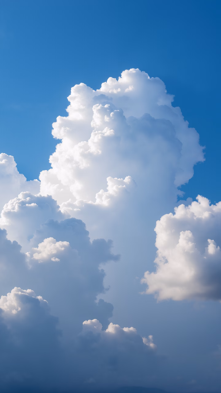 Vibrant blue sky with fluffy white clouds, evoking tranquility and vastness.