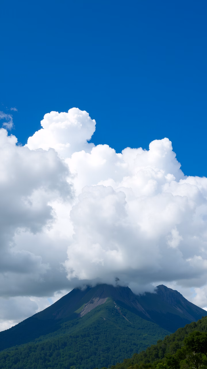 A serene mountain peak with lush greenery and dramatic clouds.