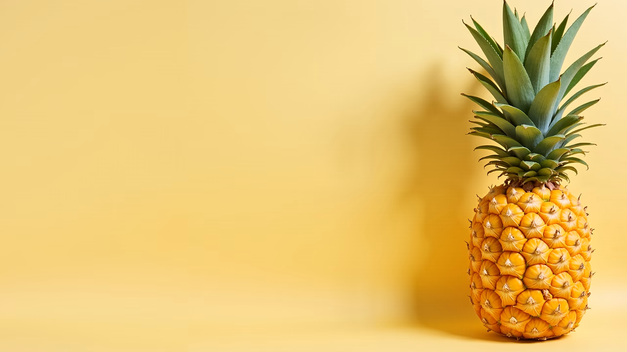 Bright pineapple on a yellow background, simple yet striking.