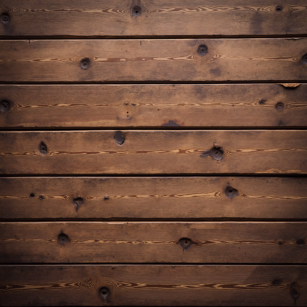 Close-up of weathered wooden planks with rich brown tones and natural textures.