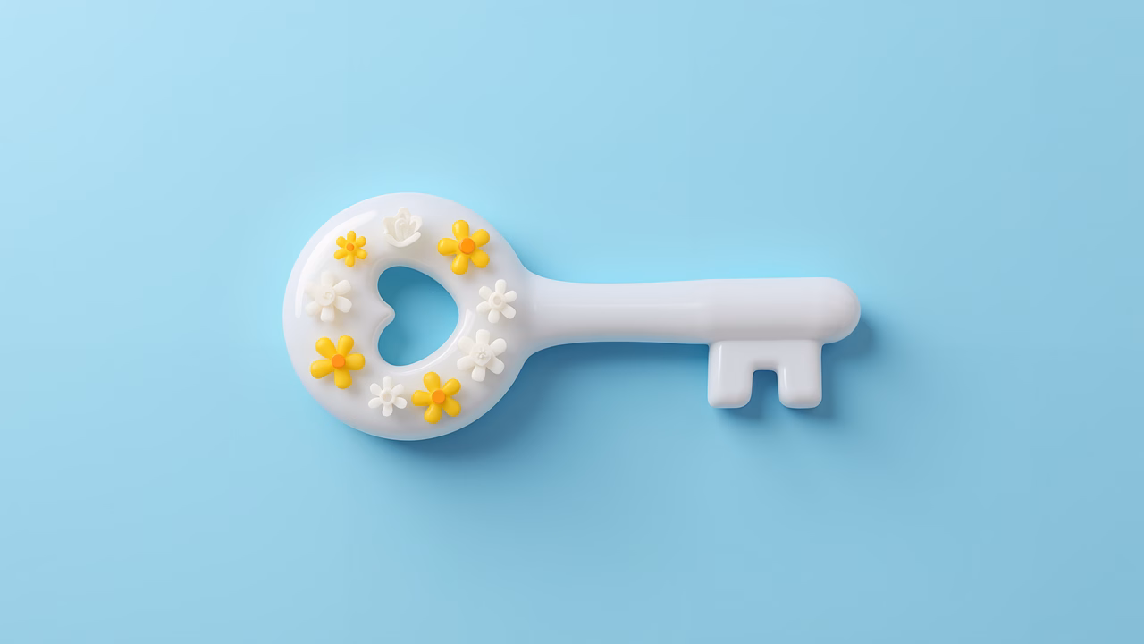 A key with flowers on a pastel blue background, symbolizing happiness and optimism.