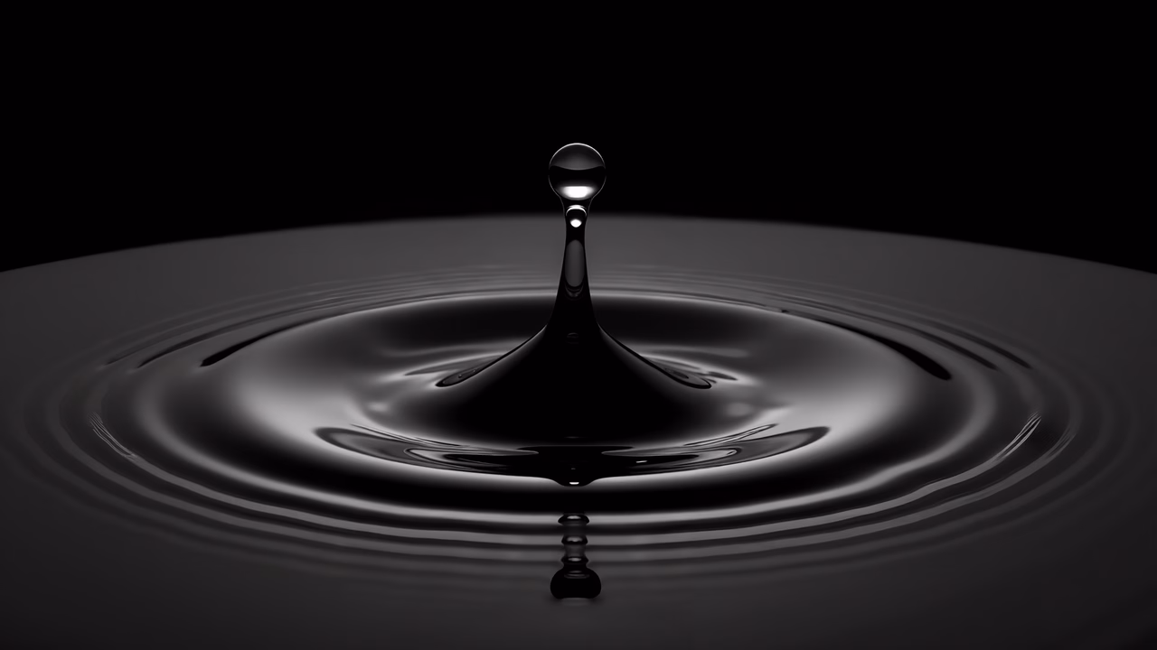 Close-up illustration of a droplet impacting a still surface, creating ripples.