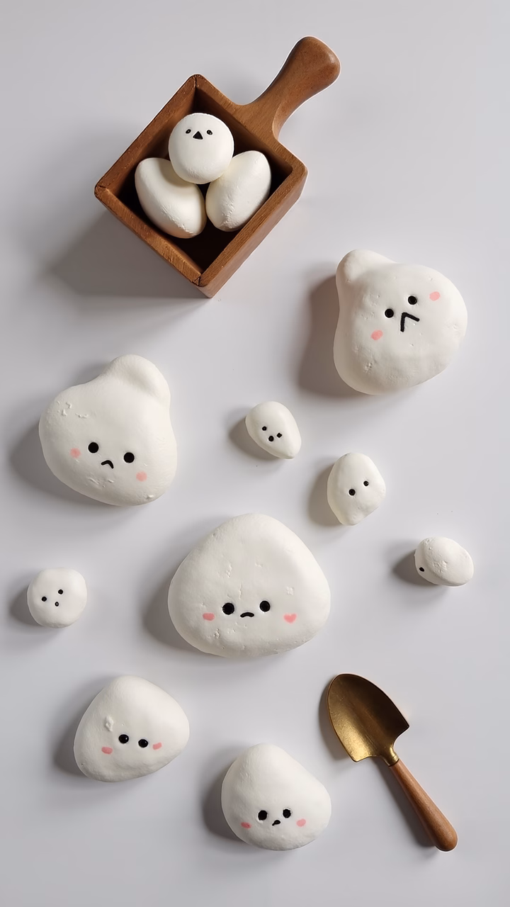 Cute cloud pastries with expressive faces, perfect for a whimsical food art piece.