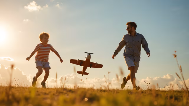 Father and Son Playing with Toy Airplane