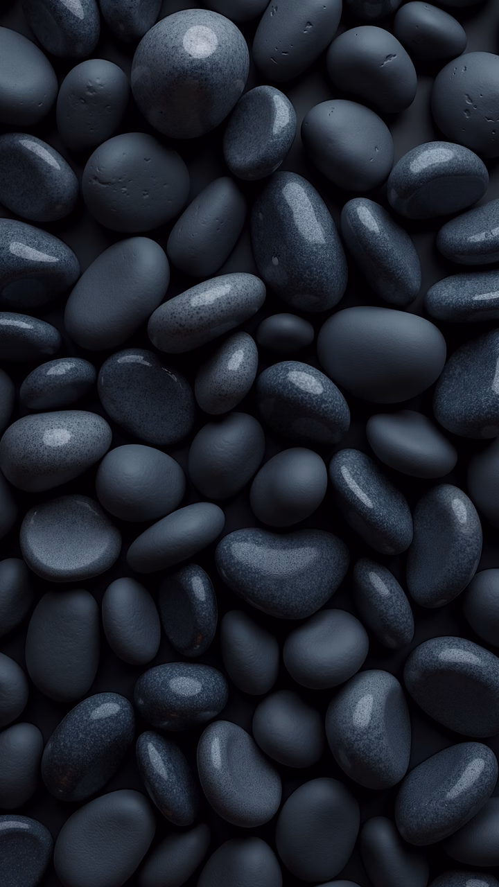 Close-up of monochromatic pebbles in shades of gray, showcasing texture and depth.